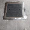 Arqueta de un almacén industrial tras ser reparada